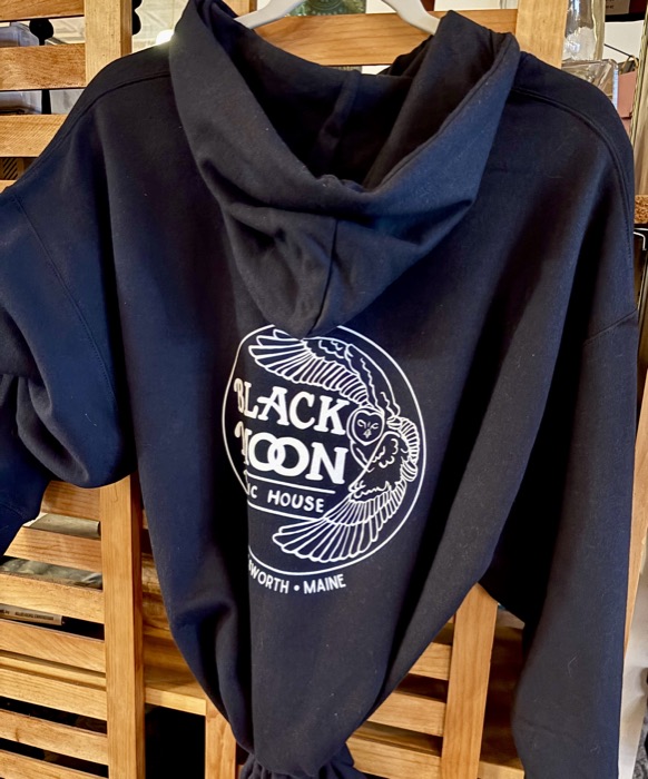 A navy pullover hoodie printed with the round Black Moon logo