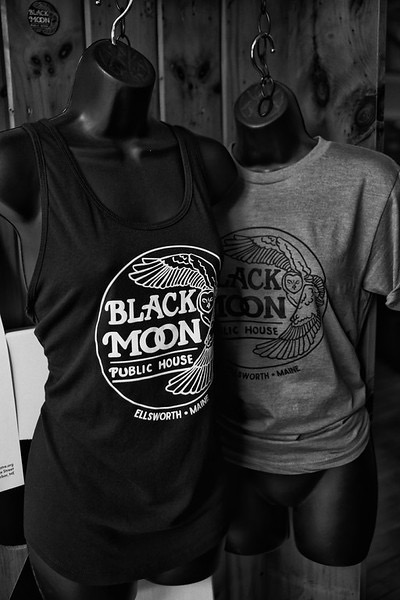 Black and grey Black Moon t-shirts on display forms