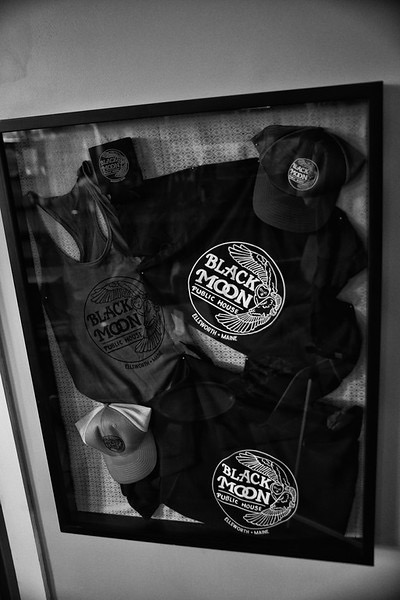 Black v-neck shirts with the Black Moon logo