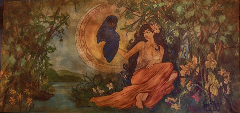 Mural of a woman in an orange dress among flowers, beside a dark moon with an owl silhouette