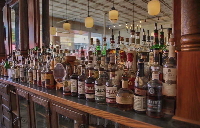 Shelves of whiskey bottles along the back bar